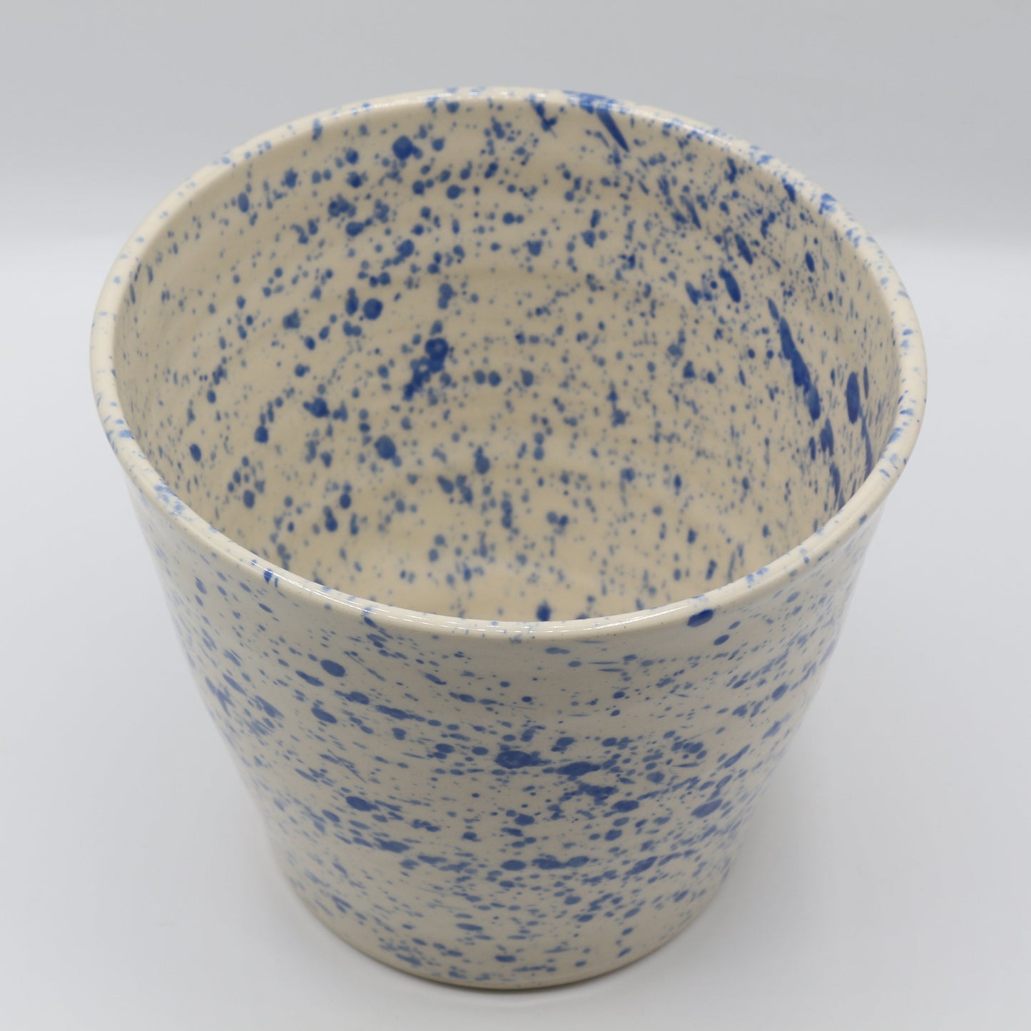 Speckled ceramic planter with blue and cream speckled pattern on a white background